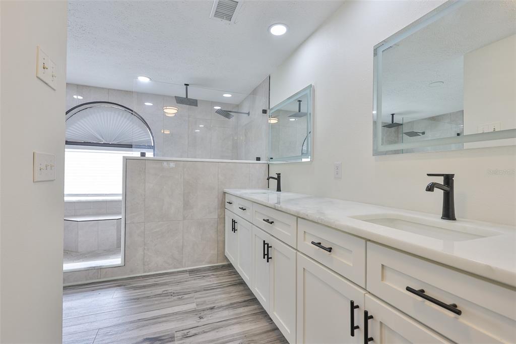 913 Allegro Lane Apollo Beach, FL 33572 - Photo 27 of 57 a bathroom with a double vanity sink and mirror