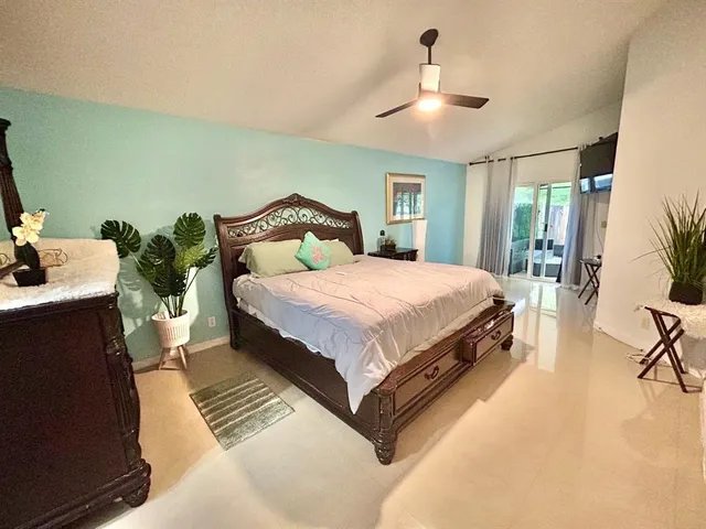 a bedroom with a bed lamp and a chandelier