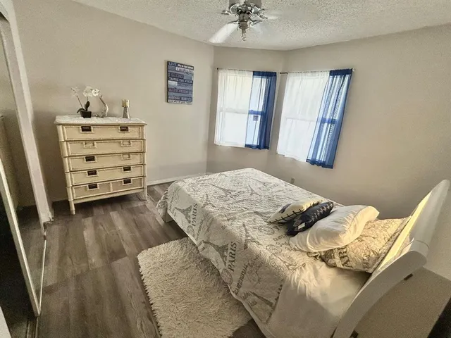 a bedroom with a bed and a television