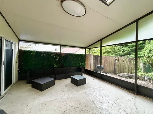 a living room with a large window and a table