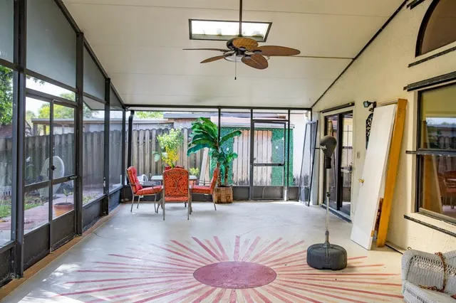 a living room with furniture and a floor to ceiling window