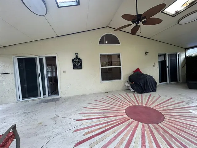 a backyard of a house with table and chairs