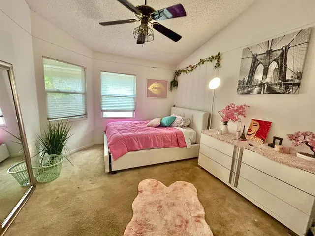 a bedroom with a bed couch and window