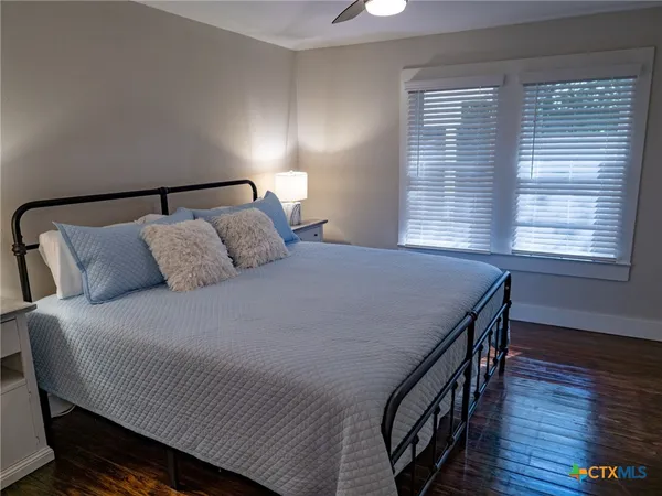 a bedroom with a bed and a night stand