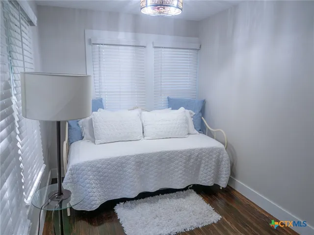 a bedroom with a bed and window