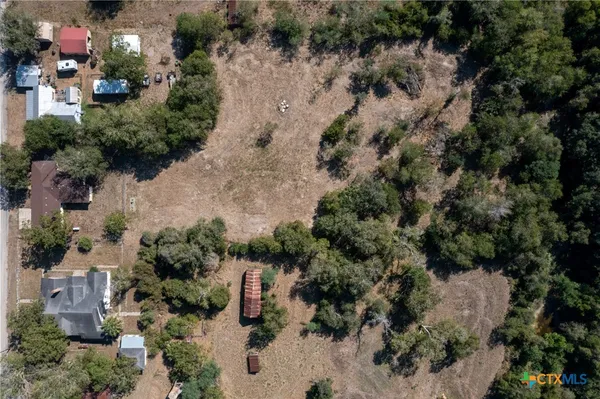 an aerial view of a house with a yard