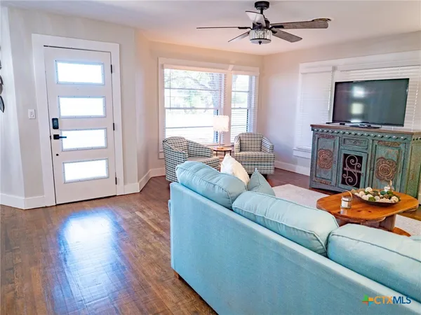 a living room with fireplace furniture and a flat screen tv