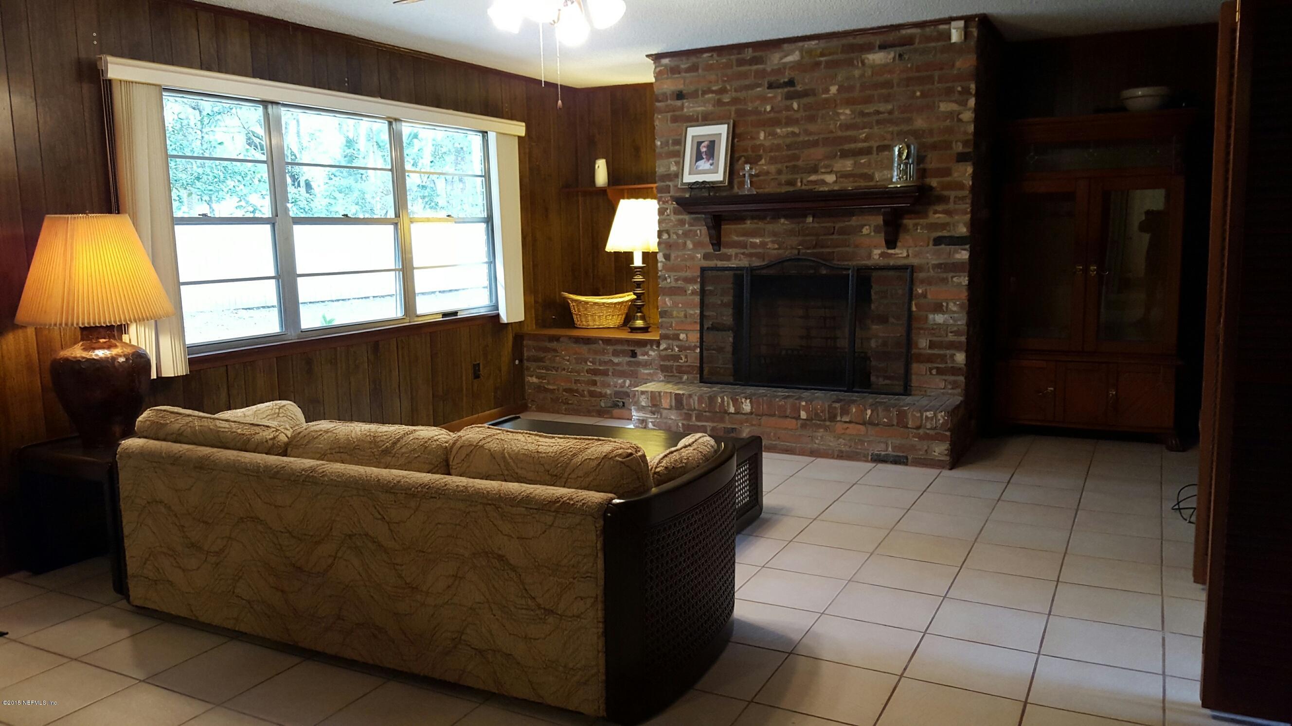 living room with brick fireplace