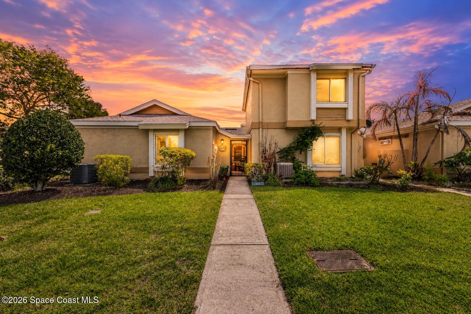 1411 Sheafe Avenue Northeast, Unit 101 Palm Bay, FL 32905 - Photo 1 of 24 a front view of a house with a yard
