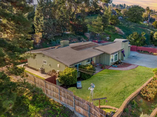 an aerial view of a house with swimming pool and garden