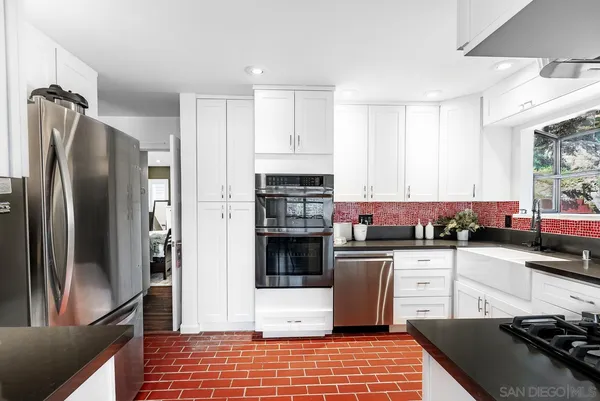 a view of a patio with couches table and chairs and potted plants