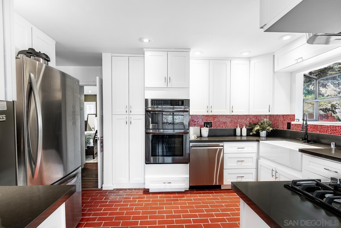 1912 Jalisco Road El Cajon, CA 92019 - Photo 11 of 38 a kitchen with stainless steel appliances kitchen island granite countertop a refrigerator and a stove top oven