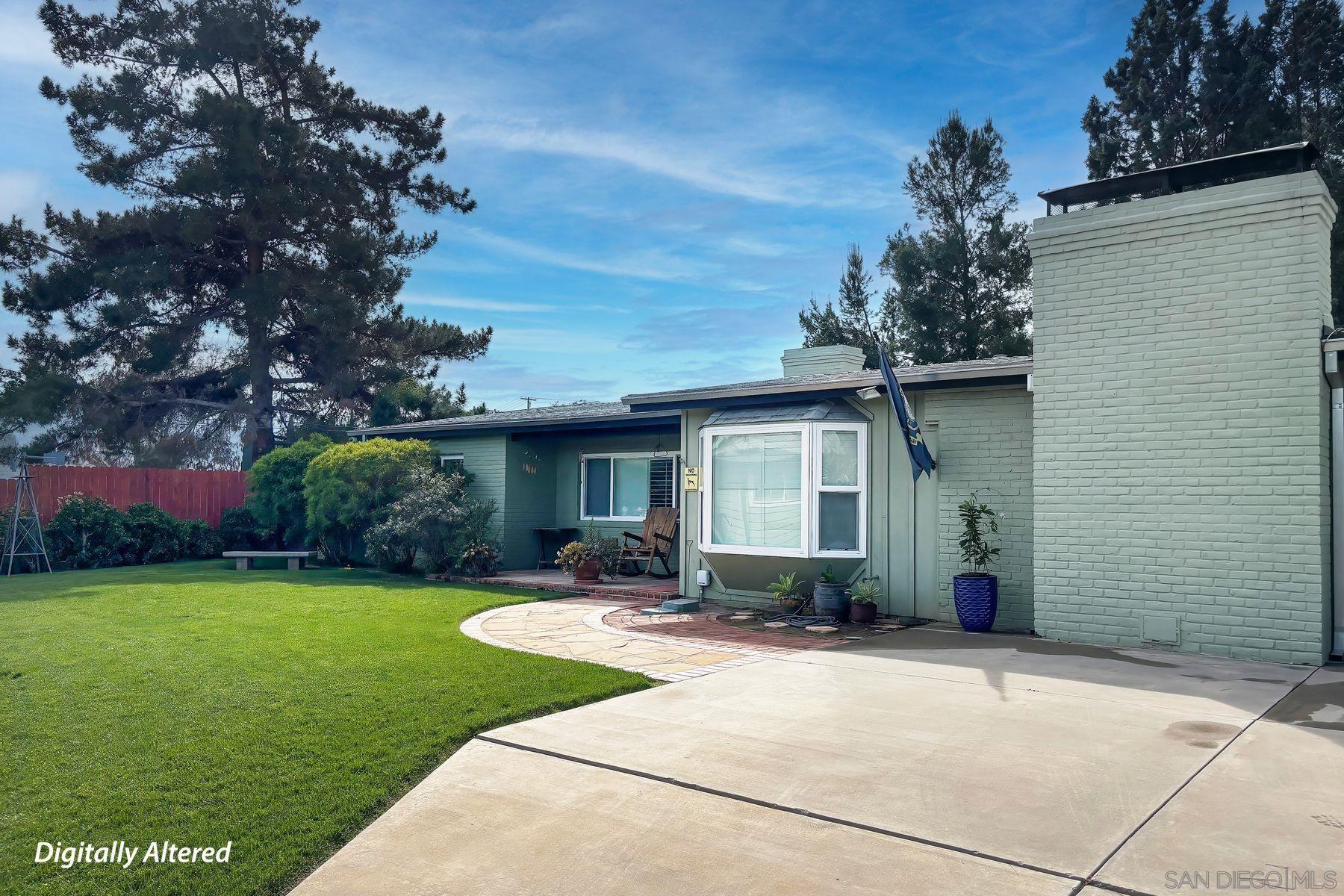 1912 Jalisco Road El Cajon, CA 92019 - Photo 13 of 38 a front view of a house with a garden and yard