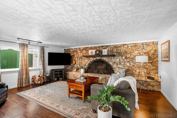 a bedroom with bed and wooden floor