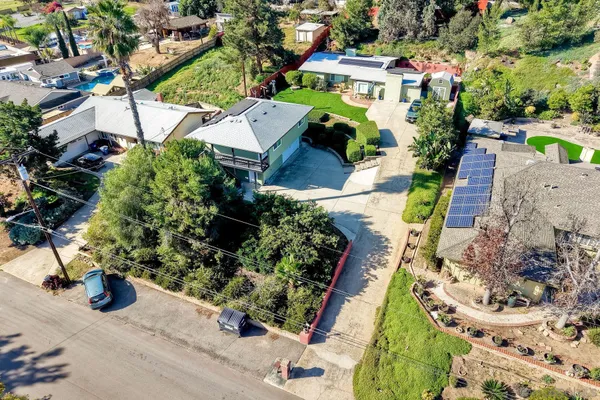 an aerial view of house with yard swimming pool and outdoor seating