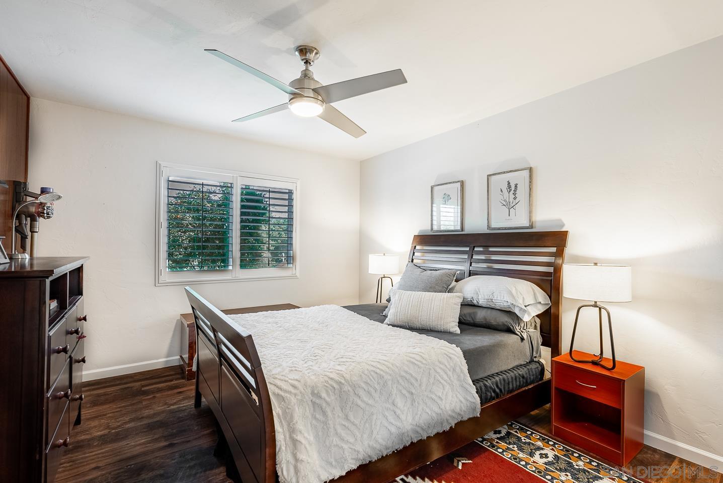 1912 Jalisco Road El Cajon, CA 92019 - Photo 23 of 38 a bedroom with a bed and a chandelier