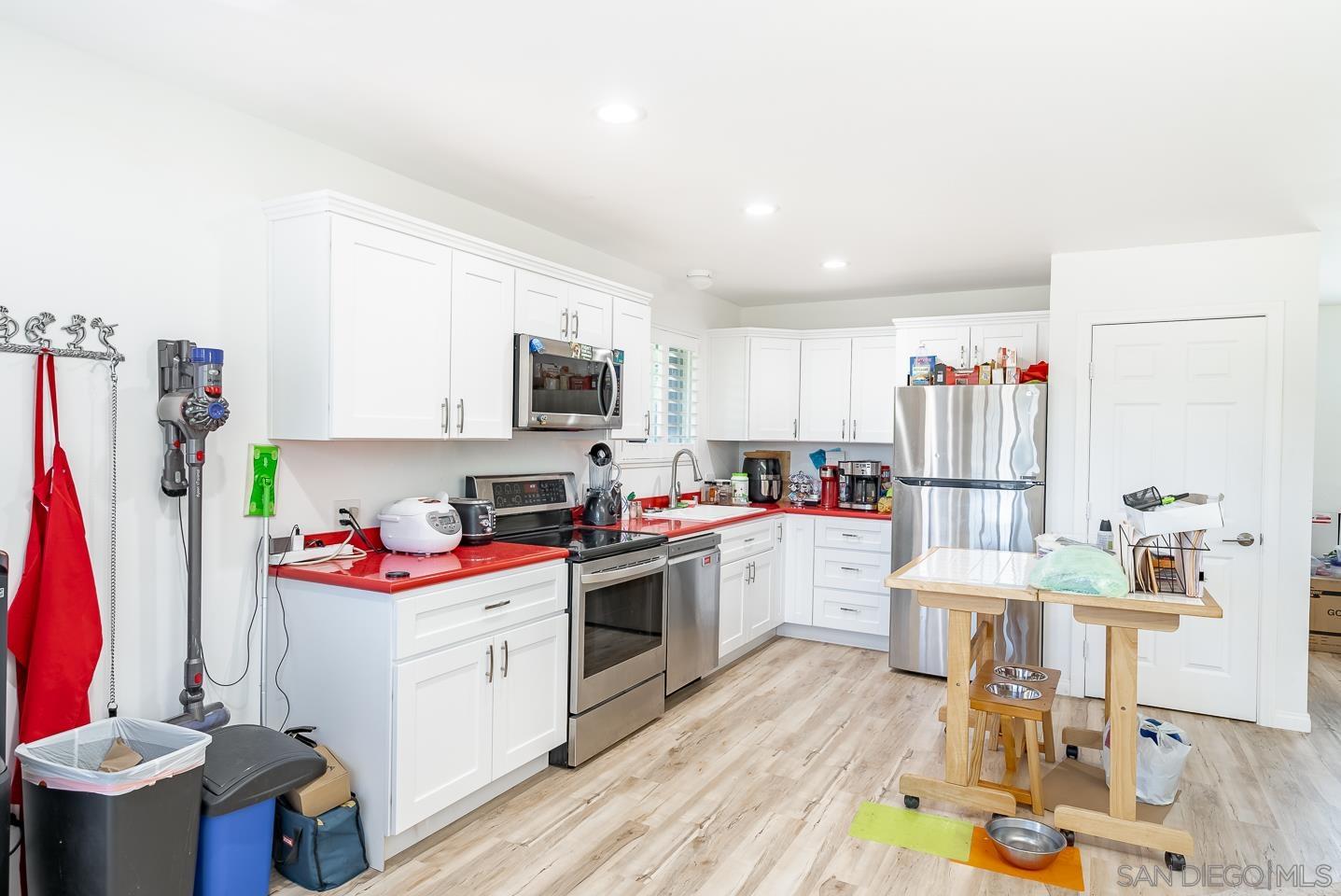 1912 Jalisco Road El Cajon, CA 92019 - Photo 27 of 38 a open kitchen with stainless steel appliances granite countertop a stove and cabinets