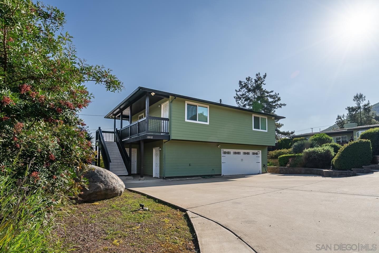 1912 Jalisco Road El Cajon, CA 92019 - Photo 5 of 38 a front view of a house with a yard and garage