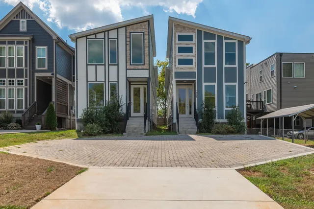 front view of a brick house with a yard