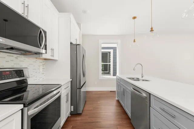 a kitchen with stainless steel appliances a sink stove and refrigerator