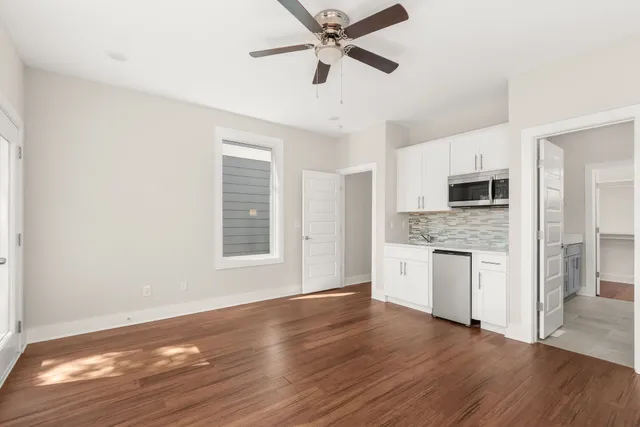 a view of a kitchen with a sink dishwasher and a fireplace