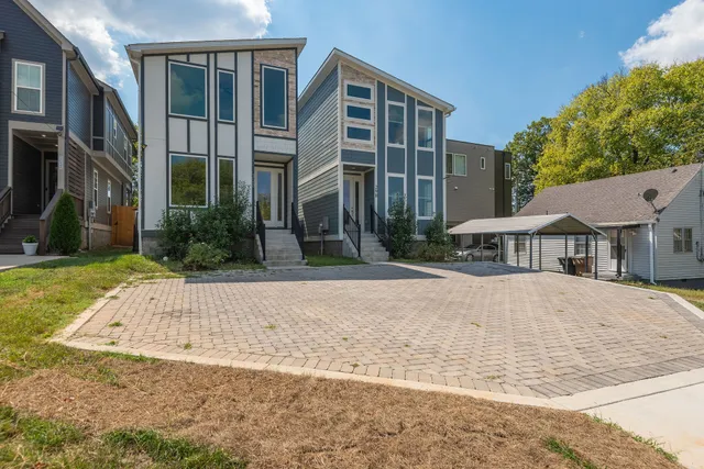 a front view of a building with a garden