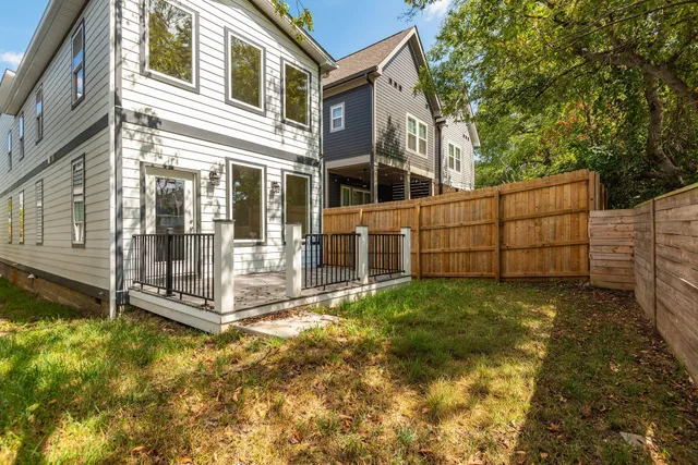 a view of a large brick building next to a yard