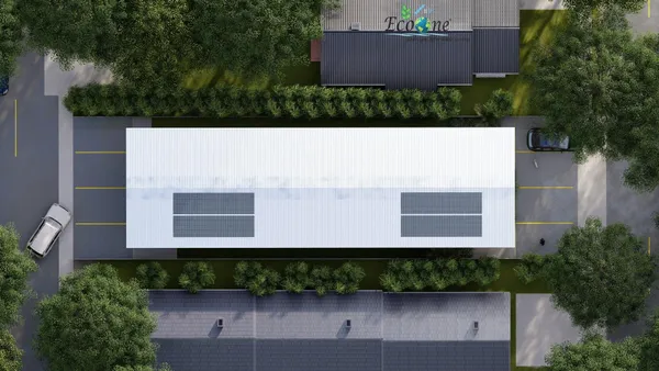 an aerial view of a house with a yard and a large tree