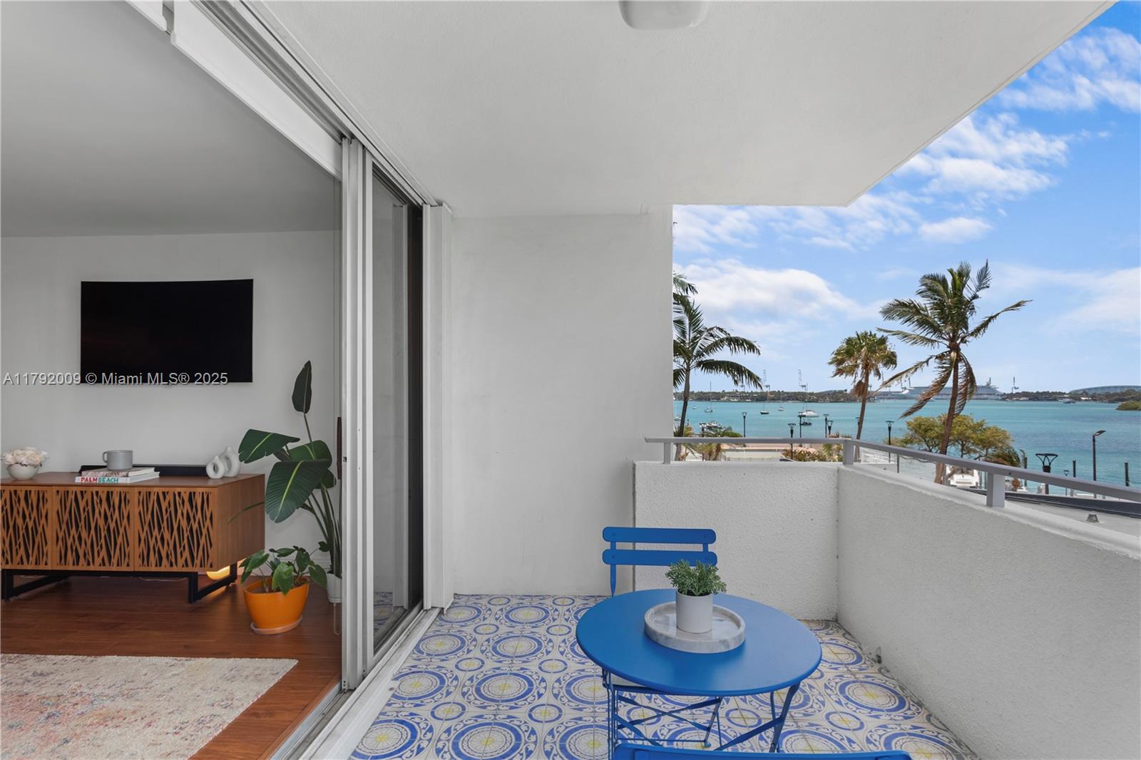 11 Island Avenue, Unit 407 Miami Beach, FL 33139 - Photo 1 of 44 a living room with furniture and a flat screen tv