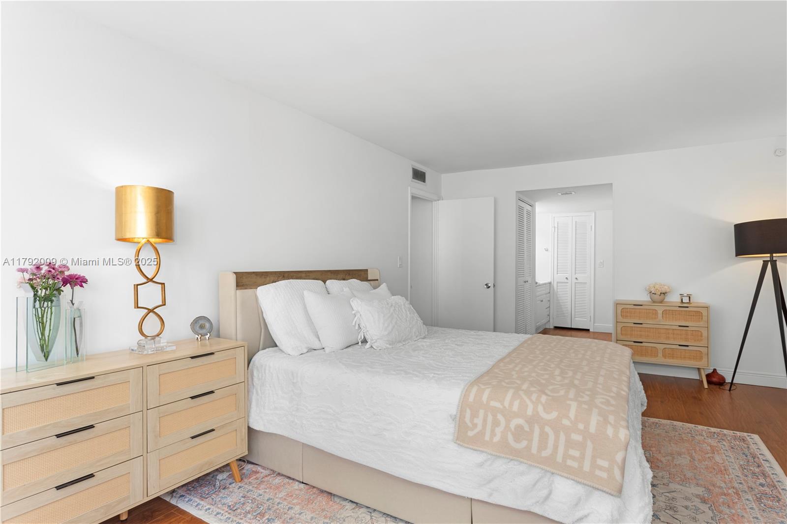 11 Island Avenue, Unit 407 Miami Beach, FL 33139 - Photo 12 of 44 a bedroom with a bed and a lamp on dresser