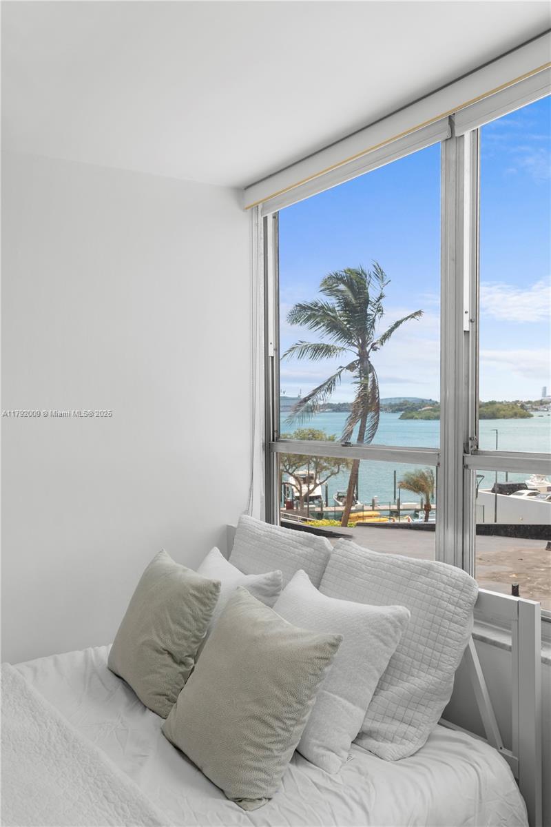 11 Island Avenue, Unit 407 Miami Beach, FL 33139 - Photo 17 of 44 a living room with a bed furniture and next to a window