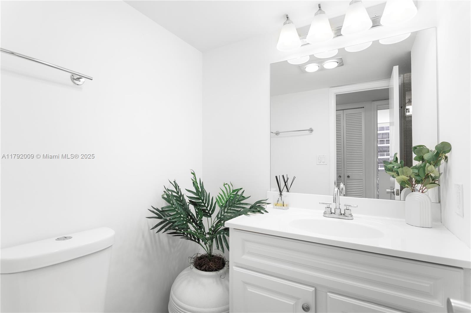 11 Island Avenue, Unit 407 Miami Beach, FL 33139 - Photo 20 of 44 a bathroom with a sink a toilet and a mirror