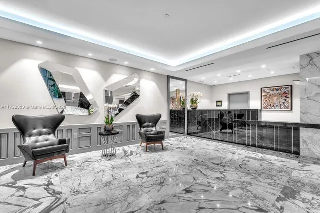 a living room with lots of furniture and a view of kitchen