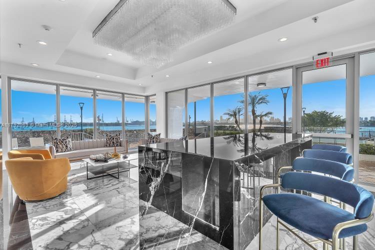 11 Island Avenue, Unit 407 Miami Beach, FL 33139 - Photo 30 of 44 a living room with lots of furniture and a view of kitchen