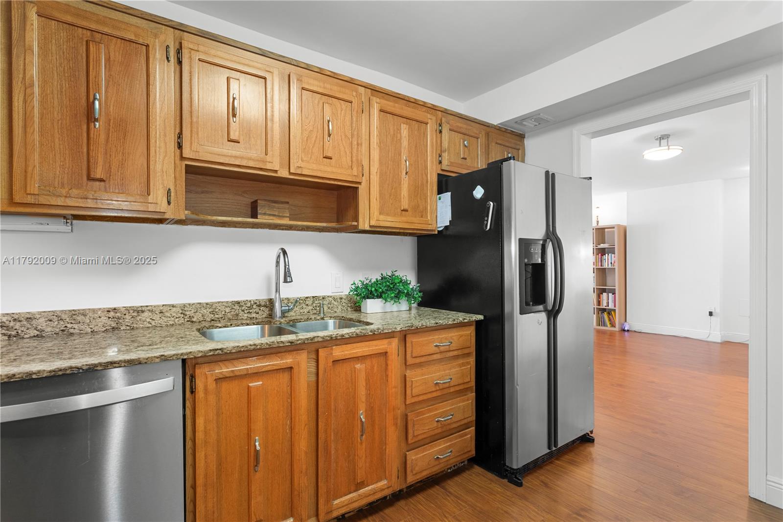 11 Island Avenue, Unit 407 Miami Beach, FL 33139 - Photo 10 of 44 a kitchen with granite countertop stainless steel appliances a refrigerator and cabinets