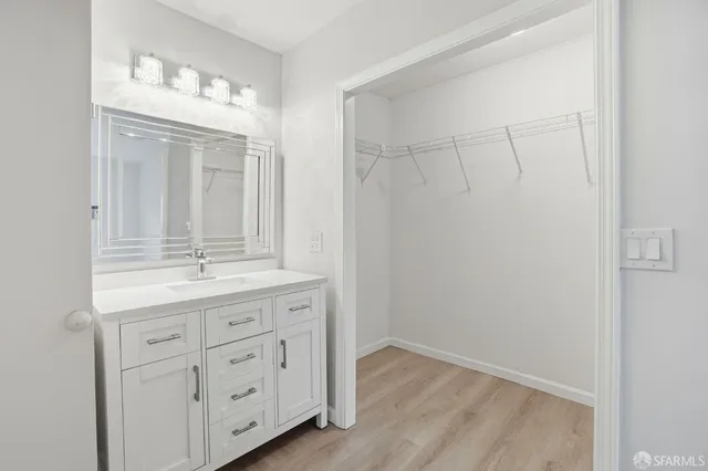 a bathroom with a granite countertop sink a mirror and a vanity