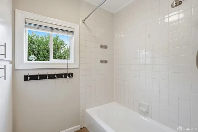 a bathroom with a bathtub and a shower