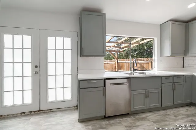 a kitchen with a sink and large window
