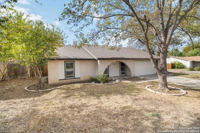 a view of a house with a yard covered in snow