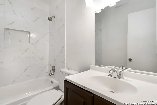 a bathroom with a sink toilet and bathtub