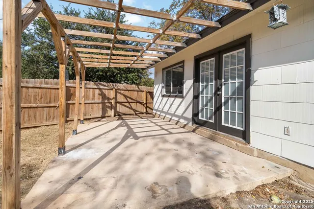 a view of a porch with wooden floor and fence