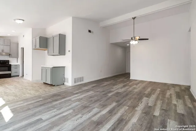 a view of a livingroom with furniture and an empty room