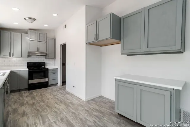 a kitchen with stainless steel appliances a refrigerator and cabinets
