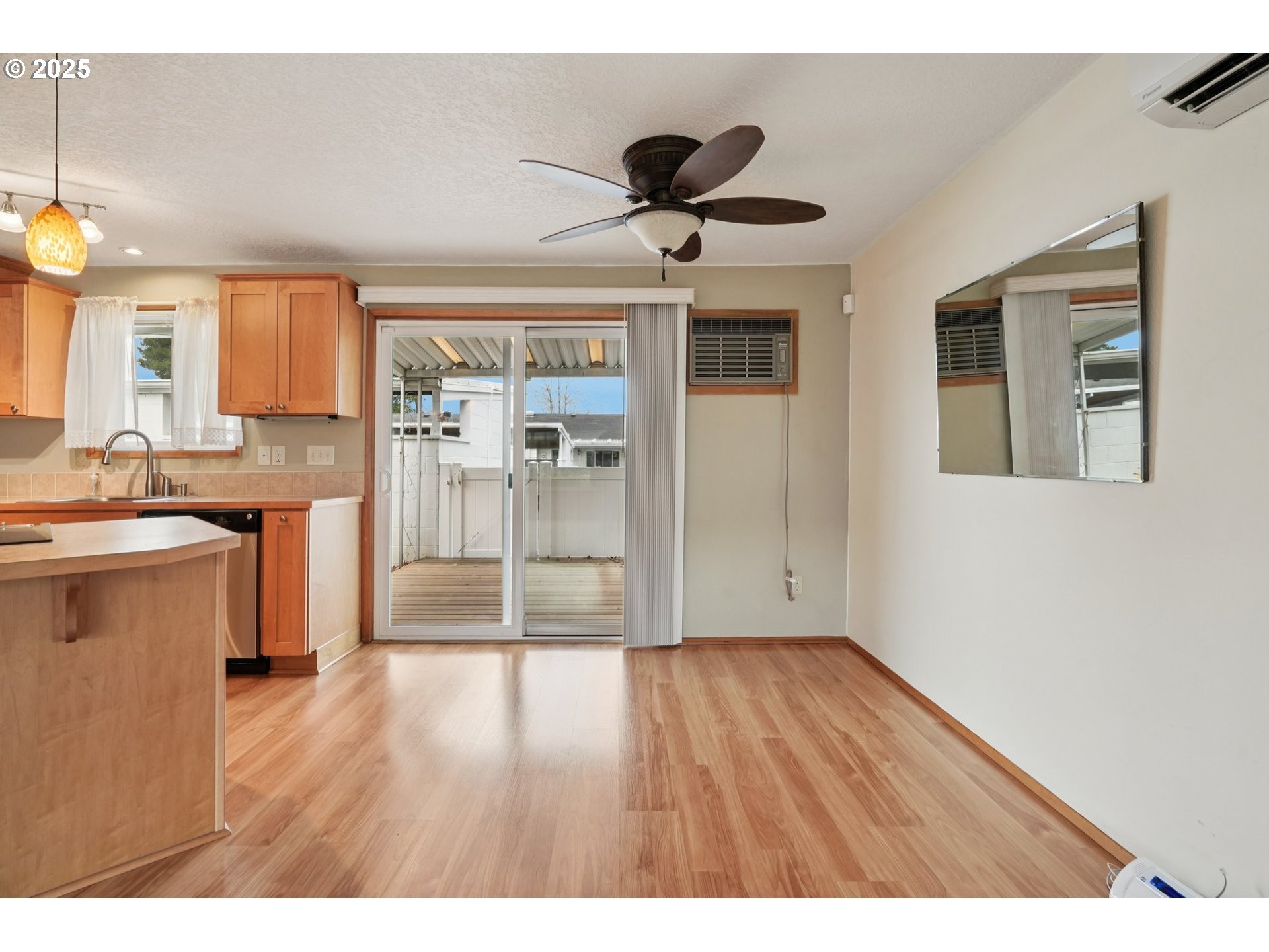 866 Northeast Fleming Avenue, Unit B83 Gresham, OR 97030 - Photo 13 of 27 a open kitchen with a sink dishwasher a refrigerator and wooden floor