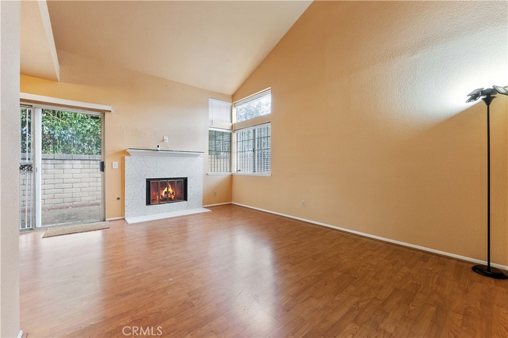 3635 Daybreak Street El Monte, CA 91732 - Photo 5 of 24 an empty room with windows a fireplace and wooden floor