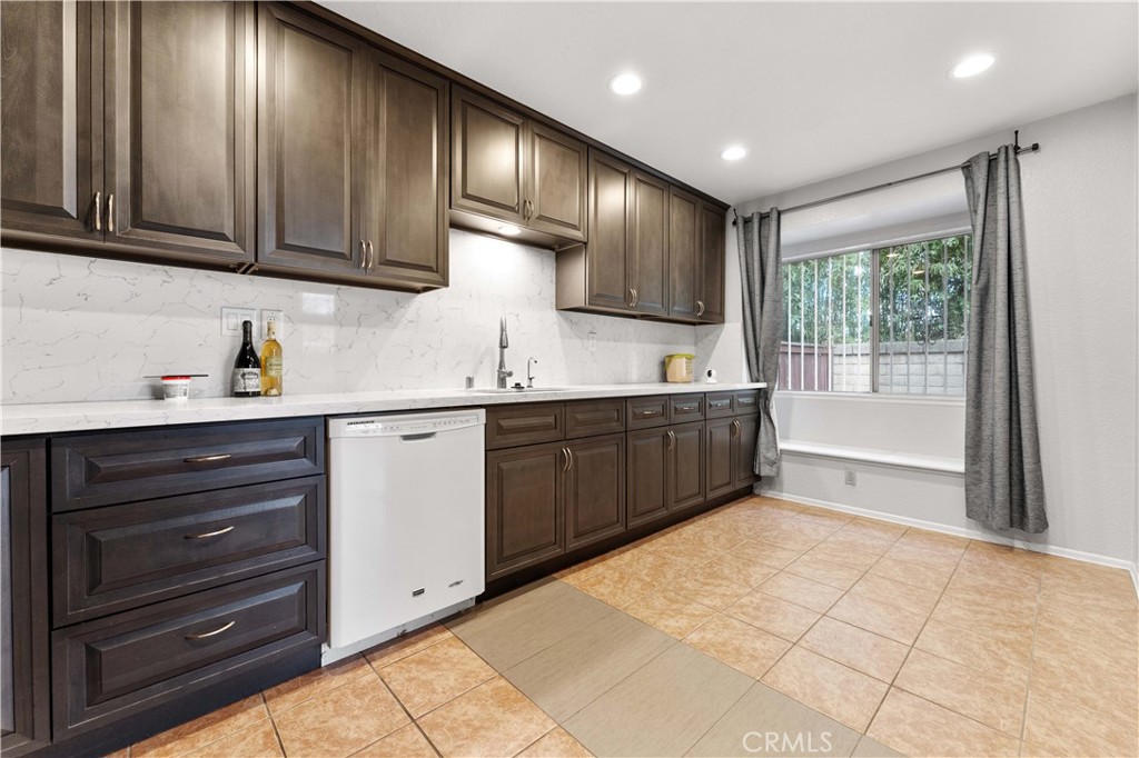 3635 Daybreak Street El Monte, CA 91732 - Photo 8 of 24 a kitchen with stainless steel appliances sink cabinets and window