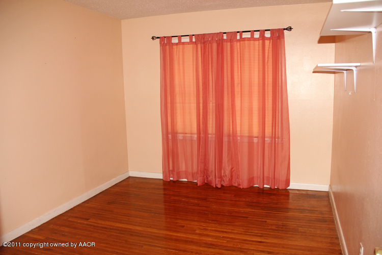4905 Parker Street Amarillo, TX 79110 - Photo 14 of 25 a view of a room with wooden floor and a window