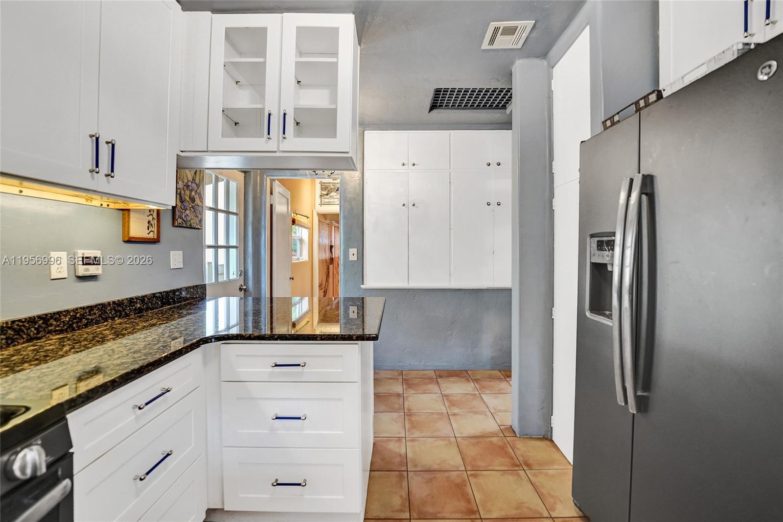 1340 Jackson Street Hollywood, FL 33019 - Photo 15 of 49 a kitchen with stainless steel appliances granite countertop a refrigerator and a stove
