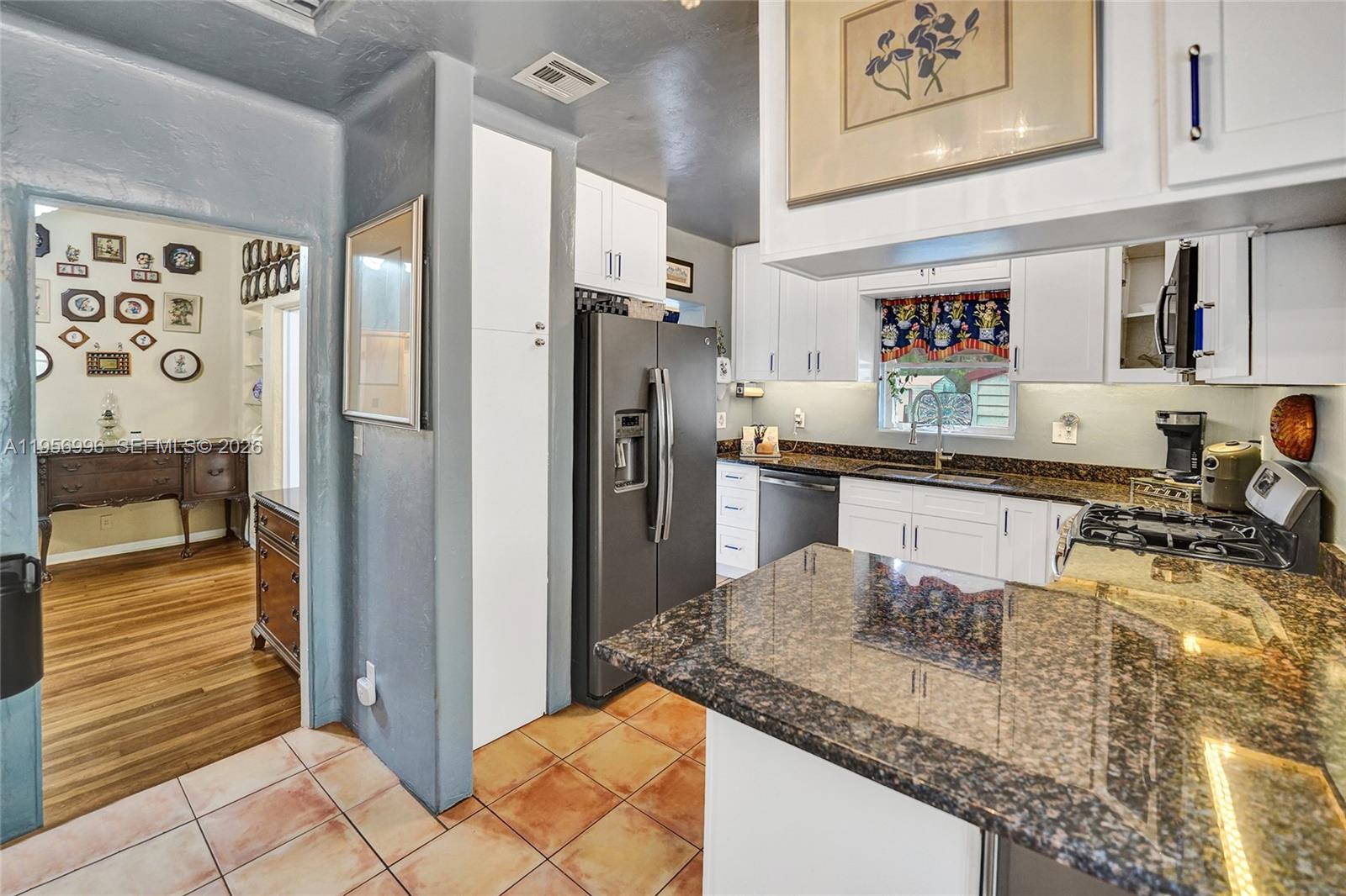 1340 Jackson Street Hollywood, FL 33019 - Photo 17 of 49 a kitchen with stainless steel appliances granite countertop a refrigerator and a sink