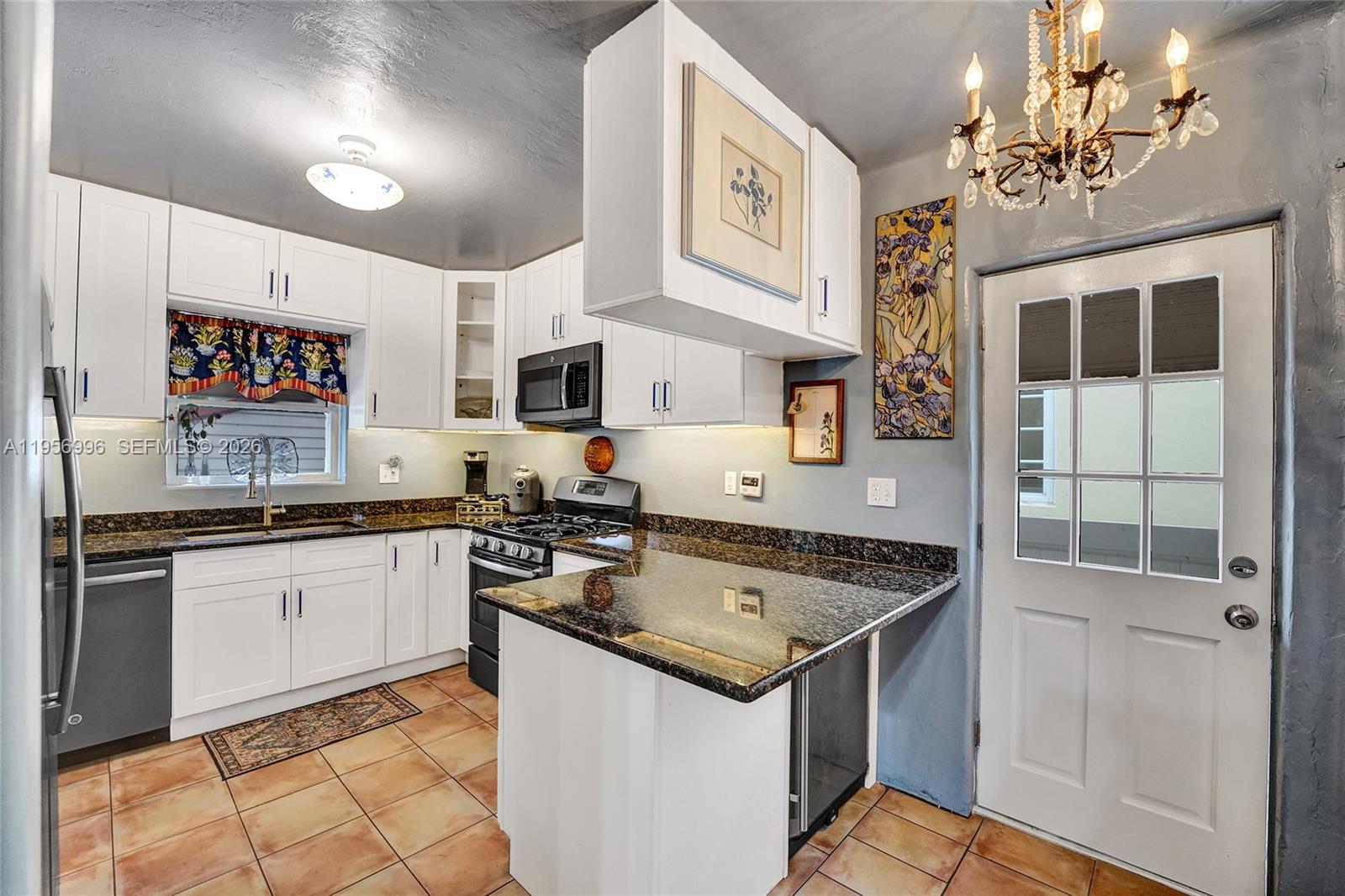 1340 Jackson Street Hollywood, FL 33019 - Photo 18 of 49 a kitchen filled with stainless steel appliances granite countertop a sink and cabinets